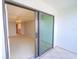 Bedroom view featuring light carpet and access to the balcony through a sliding glass door at 240 Sand Key Estates Dr # 243, Clearwater Beach, FL 33767