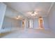 Spacious bedroom featuring a mirrored wall, neutral carpet, and a ceiling fan for added comfort at 240 Sand Key Estates Dr # 243, Clearwater Beach, FL 33767