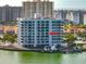 Exterior of waterfront condo building with docks, lush landscaping, and beautiful views at 240 Sand Key Estates Dr # 243, Clearwater Beach, FL 33767