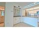 Galley kitchen with bright white cabinets, stainless appliances, and bar seating at 240 Sand Key Estates Dr # 243, Clearwater Beach, FL 33767