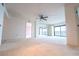The carpeted living room features a mirrored wall and a sliding door with shutters to the balcony at 240 Sand Key Estates Dr # 243, Clearwater Beach, FL 33767