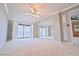 Main bedroom with neutral walls, carpet and an enormous mirrored wall and sliding glass door to the balcony at 240 Sand Key Estates Dr # 243, Clearwater Beach, FL 33767