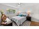 Cozy bedroom featuring a queen-sized bed with a decorative rug, complemented by natural light from the window at 2460 Northside Dr # 802, Clearwater, FL 33761