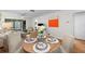 Open concept dining area features contemporary decor, wood floors, and sliding glass doors at 2460 Northside Dr # 802, Clearwater, FL 33761