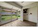 Bright Florida Room with wood-look tile flooring and views of the green backyard at 2460 Northside Dr # 802, Clearwater, FL 33761
