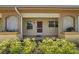 Inviting covered front entrance with decorative lattice and well-maintained landscaping, plus updated exterior paint at 2460 Northside Dr # 802, Clearwater, FL 33761