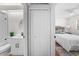Hallway connecting to bathroom featuring modern fixtures and sink; also leads to bedroom with decor and closet at 2460 Northside Dr # 802, Clearwater, FL 33761