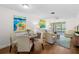 Cozy living room features a dining area, comfortable seating, and sliding glass doors to an enclosed patio at 2460 Northside Dr # 802, Clearwater, FL 33761