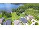 Stunning lakefront property with lush green lawn, mature trees, and a private dock, perfect for enjoying waterfront living at 2566 Lake Manor Dr, Land O Lakes, FL 34639