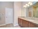 Spacious bathroom with granite countertops, dual sinks, and a large mirror at 2566 Lake Manor Dr, Land O Lakes, FL 34639