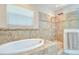 Luxurious bathroom featuring a soaking tub and a tiled walk-in shower at 2566 Lake Manor Dr, Land O Lakes, FL 34639
