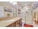 Bright bathroom featuring granite counters, tiled shower with glass door, and decor accents at 2566 Lake Manor Dr, Land O Lakes, FL 34639