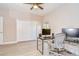 Office space showing a desk, chair, and dual monitors, with a ceiling fan for comfortable working at 2566 Lake Manor Dr, Land O Lakes, FL 34639