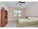 Cozy bedroom featuring a ceiling fan, closet, and a large window for natural light at 2566 Lake Manor Dr, Land O Lakes, FL 34639