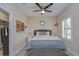 Comfortable bedroom with a ceiling fan and a large window that provides natural light at 2566 Lake Manor Dr, Land O Lakes, FL 34639