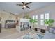 Spacious bedroom features decorative shelving, ceiling fans, windows and space to work and rest at 2566 Lake Manor Dr, Land O Lakes, FL 34639