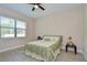 Bright bedroom with a large window and ceiling fan, and light laminate flooring at 2566 Lake Manor Dr, Land O Lakes, FL 34639