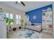 Bright bedroom with a blue accent wall, shelving, and a ceiling fan at 2566 Lake Manor Dr, Land O Lakes, FL 34639