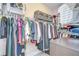 Walk-in closet features racks of clothing, shelves, and drawers for organized storage at 2566 Lake Manor Dr, Land O Lakes, FL 34639