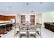 An open dining area featuring a table with seating for eight, stylish lighting, and decorative built-in shelving at 2566 Lake Manor Dr, Land O Lakes, FL 34639