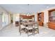 Open-concept dining room with a large wood table, seating for six, and seamless access to the kitchen at 2566 Lake Manor Dr, Land O Lakes, FL 34639