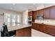 Modern kitchen with stainless appliances, granite countertops, a central island with bar seating, and outdoor access at 2566 Lake Manor Dr, Land O Lakes, FL 34639