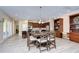 Open-concept kitchen with wood cabinets, granite countertops, large island and adjoining dining area at 2566 Lake Manor Dr, Land O Lakes, FL 34639
