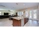 Modern kitchen island with stainless steel appliances and an adjacent dining area at 2566 Lake Manor Dr, Land O Lakes, FL 34639