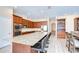 Gourmet kitchen with granite counters, stainless appliances, breakfast bar, and seamless access to dining area at 2566 Lake Manor Dr, Land O Lakes, FL 34639