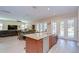 Large kitchen island featuring bar seating, granite countertop, stainless steel dishwasher, and exterior access at 2566 Lake Manor Dr, Land O Lakes, FL 34639