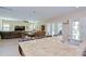 Modern kitchen island features a granite countertop, stainless steel sink, and bar seating in a bright, open layout at 2566 Lake Manor Dr, Land O Lakes, FL 34639