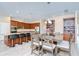 Spacious kitchen with breakfast bar, granite countertops, dark wood cabinetry, stainless appliances, and tile backsplash at 2566 Lake Manor Dr, Land O Lakes, FL 34639