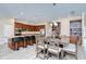 Eat-in kitchen features an island with seating, a dining table, and modern stainless-steel appliances at 2566 Lake Manor Dr, Land O Lakes, FL 34639