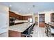 Gourmet kitchen features stainless appliances, granite countertops, a large island, and seamless access to dining area at 2566 Lake Manor Dr, Land O Lakes, FL 34639