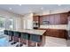 Gourmet kitchen with stainless steel appliances, breakfast bar and access to the outdoor pool area at 2566 Lake Manor Dr, Land O Lakes, FL 34639