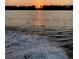 Beautiful sunset view over the lake with calm waters at 2566 Lake Manor Dr, Land O Lakes, FL 34639