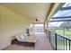 Covered lanai with lounge chairs, tile floor, and views of the backyard and pool at 2566 Lake Manor Dr, Land O Lakes, FL 34639
