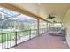 Spacious, screened-in lanai with room for dining and relaxing overlooking a pool at 2566 Lake Manor Dr, Land O Lakes, FL 34639