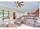 Bright and spacious living room featuring an open floor plan, modern ceiling fan, and luxury vinyl flooring at 2566 Lake Manor Dr, Land O Lakes, FL 34639