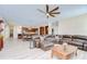 An open-concept living room, eat-in kitchen with a large dining table, and updated flooring throughout at 2566 Lake Manor Dr, Land O Lakes, FL 34639