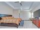 Main bedroom boasting a ceiling fan, ample natural light, and a stylish dresser for a cozy feel at 2566 Lake Manor Dr, Land O Lakes, FL 34639