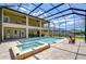 The backyard offers a screened-in pool, spa, and lounge area, perfect for relaxation and outdoor enjoyment at 2566 Lake Manor Dr, Land O Lakes, FL 34639