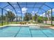 Gorgeous pool area with an enclosed screen and lake views at 2566 Lake Manor Dr, Land O Lakes, FL 34639