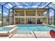 A lovely pool and spa area on the patio of a two-story home at 2566 Lake Manor Dr, Land O Lakes, FL 34639
