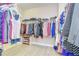 Spacious walk-in closet with ample hanging space and built-in shoe storage for organization at 2566 Lake Manor Dr, Land O Lakes, FL 34639