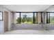 Bedroom with large window offering natural light and views, plus floor-to-ceiling mirror at 2621 Cove Cay Dr # 302, Clearwater, FL 33760