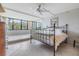 Bright bedroom featuring tile floors, large windows with views, and a comfortable bed at 2621 Cove Cay Dr # 302, Clearwater, FL 33760