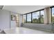 Bright bedroom featuring large windows with views, tile floors, and neutral decor at 2621 Cove Cay Dr # 302, Clearwater, FL 33760