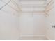 Walk in closet with white walls, neutral tile floors, and white wired shelving at 2621 Cove Cay Dr # 302, Clearwater, FL 33760