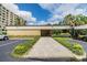 Inviting clubhouse entrance with well-maintained landscaping and convenient parking at 2621 Cove Cay Dr # 302, Clearwater, FL 33760